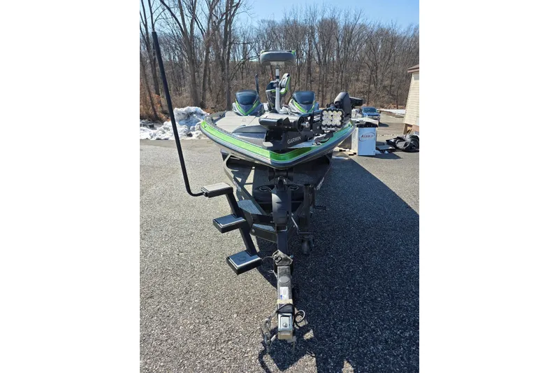 Slide: The Image of 2022 Caymas CX 21 boat on trailer, parked outdoors on a sunny day. - 3