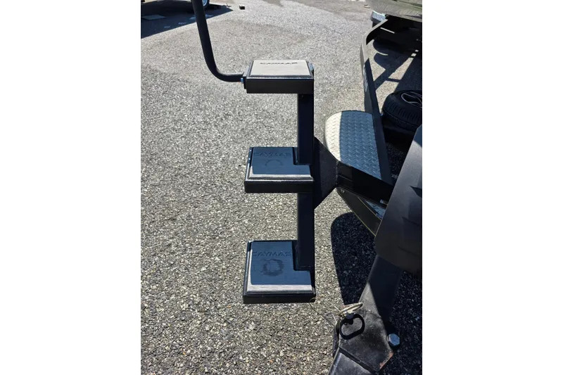 Slide: The Image of 2022 Caymas CX 21 boat trailer steps on asphalt surface. - 4