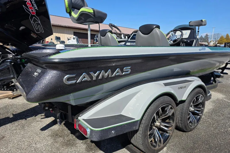 Slide: The Image of 2022 Caymas CX 21 boat with sleek design and dual-axle trailer. - 6