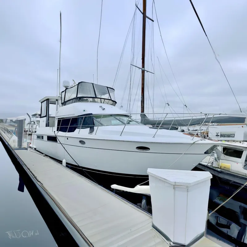 The Image of 1996 Carver 500 Cockpit Motor Yacht docked at marina. - 0