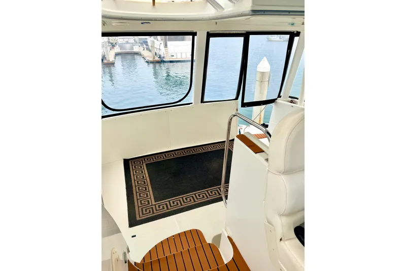 Slide: The Image of Interior view of 1996 Carver 500 Cockpit Motor Yacht with marina backdrop. - 10