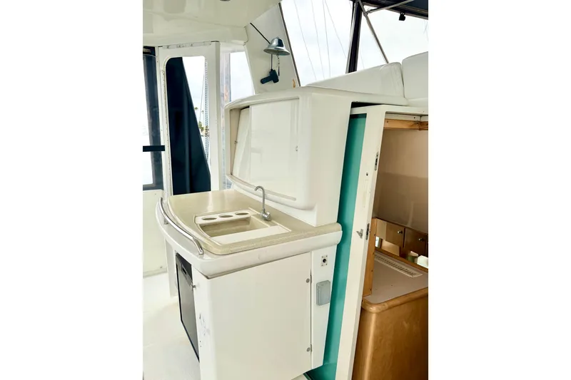 Slide: The Image of 1996 Carver 500 Cockpit Motor Yacht interior with kitchenette and sink. - 11