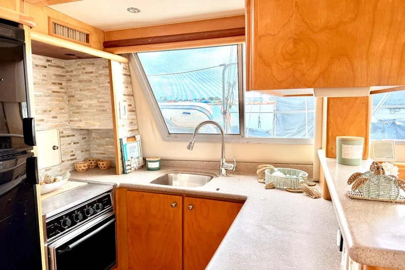 Slide: The Image of Interior of 1996 Carver 500 Cockpit Motor Yacht kitchen with modern amenities. - 18
