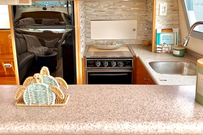 Slide: The Image of Interior of 1996 Carver 500 Cockpit Motor Yacht kitchen with stove, sink, and decor. - 20