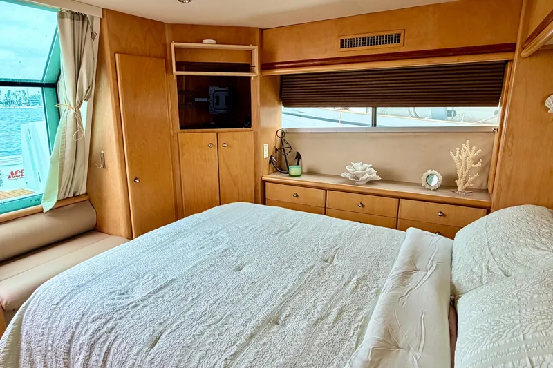 Slide: The Image of Luxurious bedroom interior of 1996 Carver 500 Cockpit Motor Yacht with elegant decor. - 21