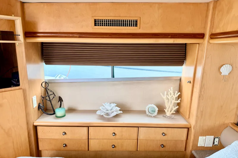 Slide: The Image of Interior of 1996 Carver 500 Cockpit Motor Yacht with wooden cabinetry and decorative items. - 23