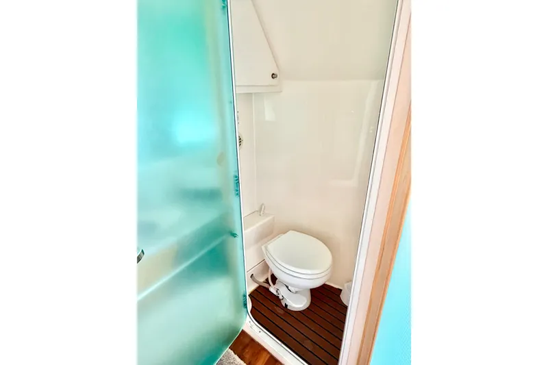 Slide: The Image of Bathroom in 1996 Carver 500 Cockpit Motor Yacht with frosted glass door and wooden floor. - 26