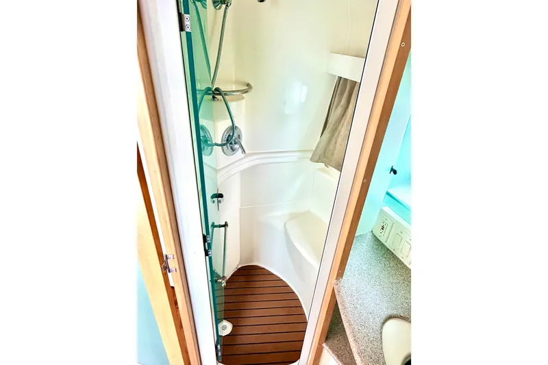 Slide: The Image of Shower area in 1996 Carver 500 Cockpit Motor Yacht with wooden floor and modern fixtures. - 27