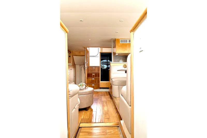 Slide: The Image of Interior of 1996 Carver 500 Cockpit Motor Yacht, featuring elegant wood finishes and plush seating. - 28