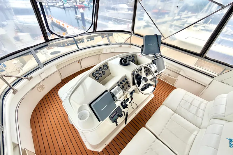 Slide: The Image of 1996 Carver 500 Cockpit Motor Yacht helm with modern navigation equipment and luxurious seating. - 4
