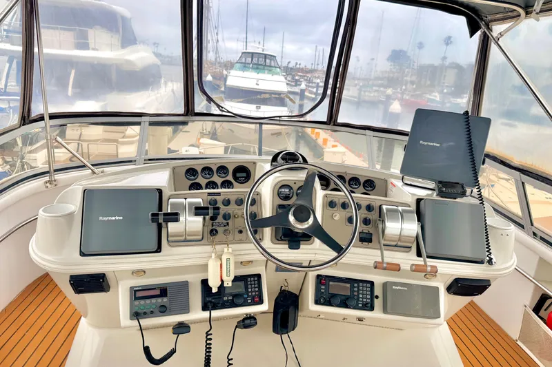 Slide: The Image of 1996 Carver 500 Cockpit Motor Yacht helm with Raymarine navigation equipment and steering wheel. - 6