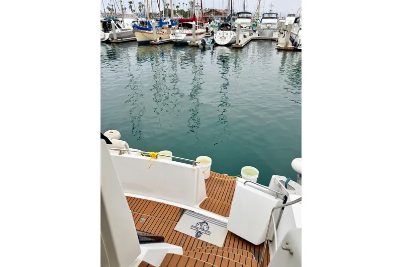 Slide: The Image of 1996 Carver 500 Cockpit Motor Yacht docked in a marina, surrounded by other boats. - 8