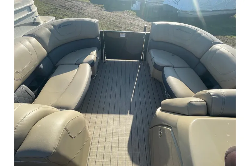 Slide: The Image of 2019 Starcraft SLS 3 boat interior with beige seating and spacious deck. - 3