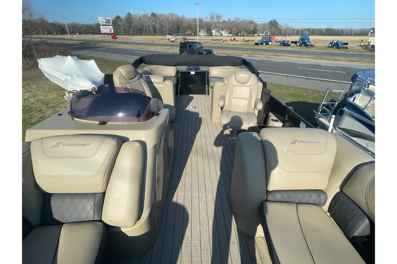 Slide: The Image of 2019 Starcraft SLS 3 pontoon boat with beige seating and open deck layout. - 6