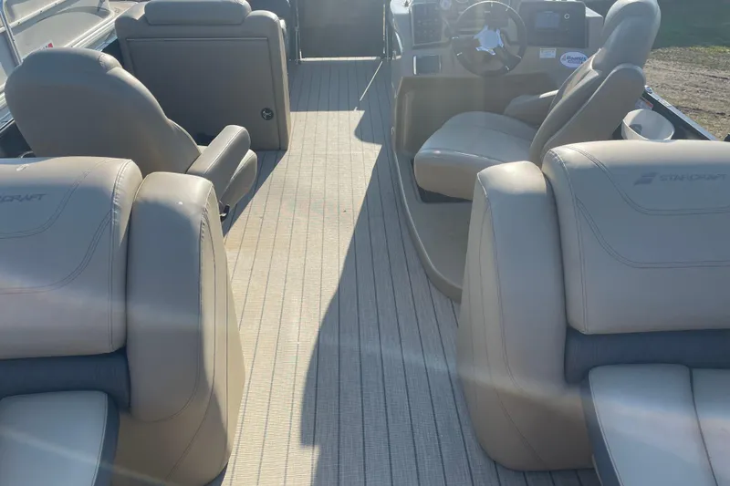 Slide: The Image of Interior of 2019 Starcraft SLS 3 boat with beige seating and steering console. - 8