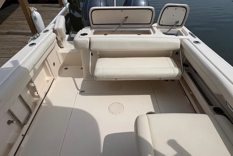 Slide: The Image of 2019 Grady-White Freedom 275 boat interior with seating and storage compartments. - 17