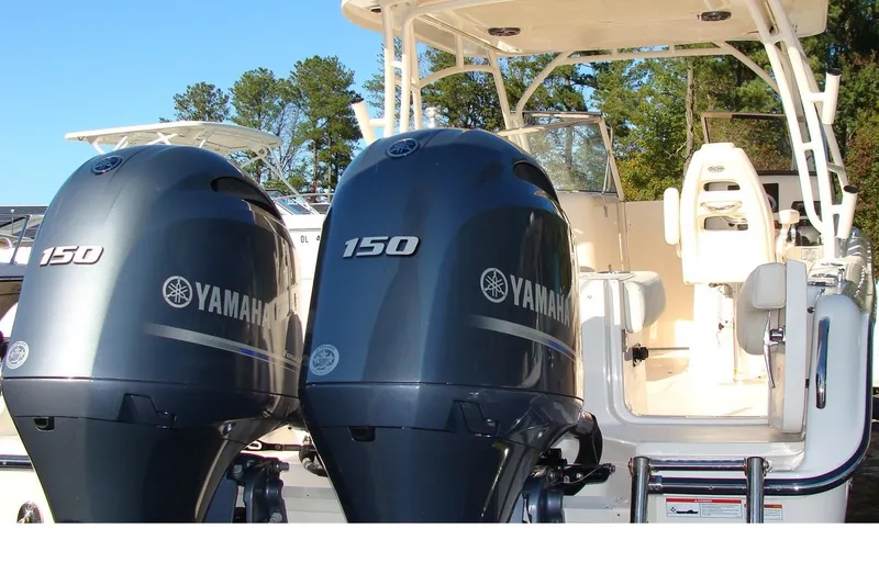 Slide: The Image of 2019 Grady-White Freedom 275 boat with dual Yamaha 150 engines, white seating, and canopy. - 2