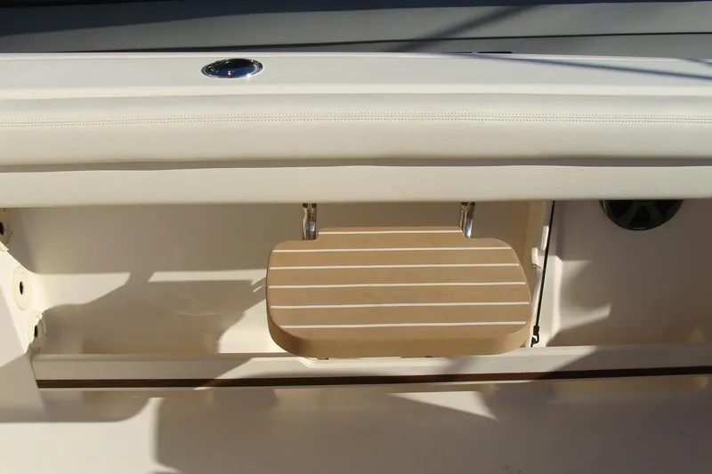 Slide: The Image of 2019 Grady-White Freedom 275 boat interior with foldable wooden step. - 25