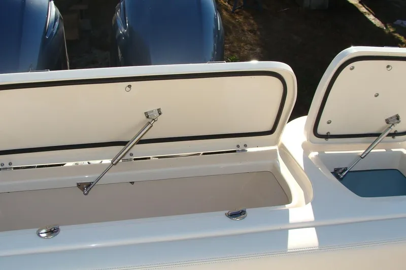 Slide: The Image of 2019 Grady-White Freedom 275 boat storage compartments open, showcasing interior space. - 9