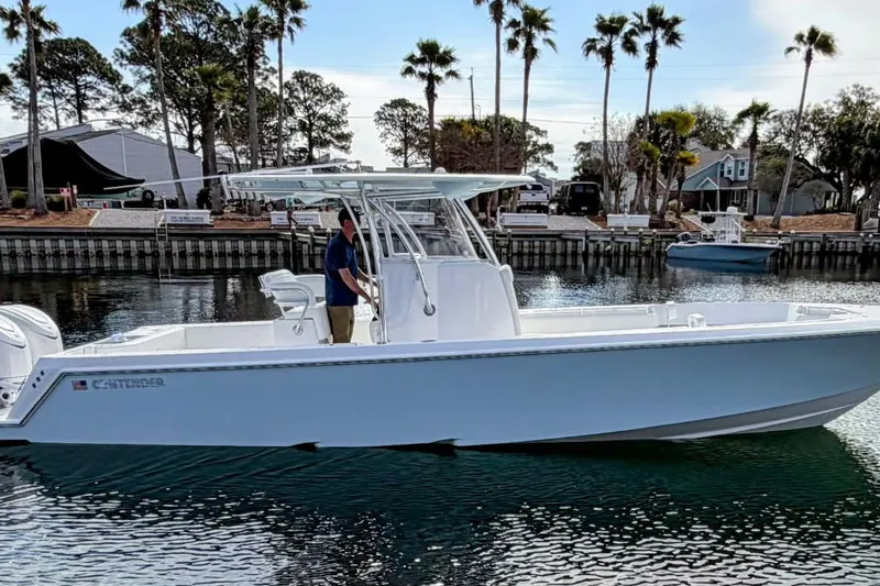 The Image of 2026 Contender 32 ST boat on trailer, parked outdoors under clear sky. - 0
