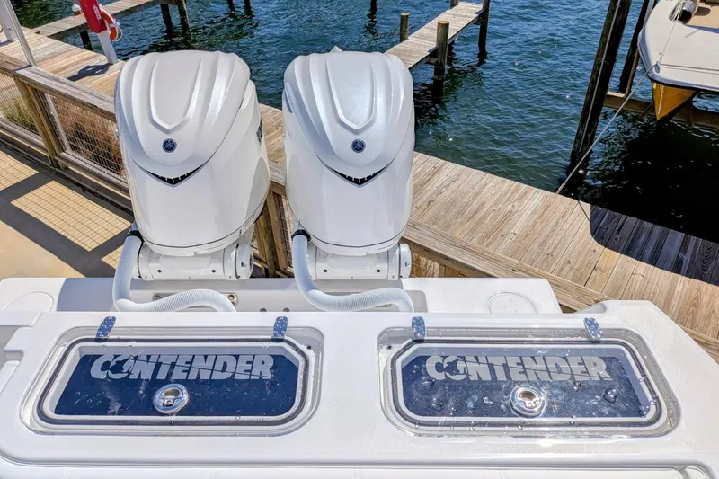 Slide: The Image of 2026 Contender 32 ST boat docked, showcasing sleek design and spacious deck layout. - 18