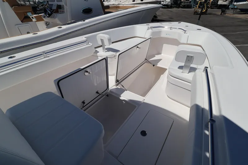 Slide: The Image of 2026 Contender 32 ST boat interior with open storage compartments and seating. - 20