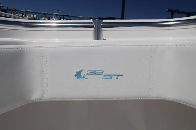 Slide: The Image of 2026 Contender 32 ST boat interior with logo detail, featuring sleek white upholstery. - 24