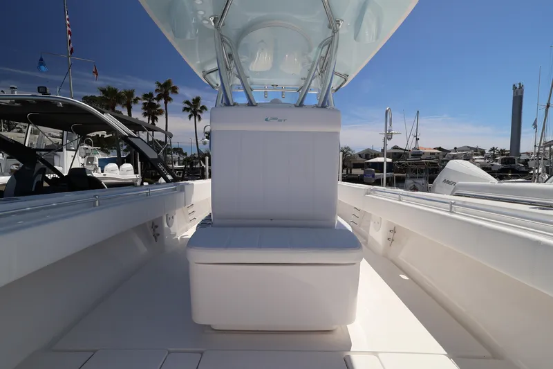 Slide: The Image of 2026 Contender 32 ST boat interior with seating, docked at marina under clear sky. - 29