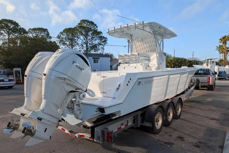 Slide: The Image of 2026 Contender 32 ST boat on trailer with Yamaha engine, parked outdoors. - 3