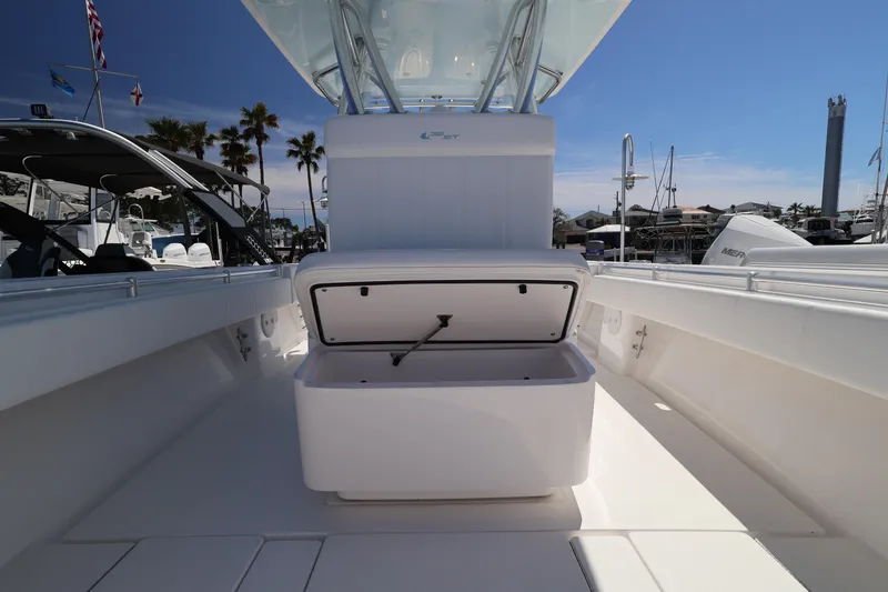 Slide: The Image of 2026 Contender 32 ST boat with open storage compartment, docked under clear blue sky. - 30