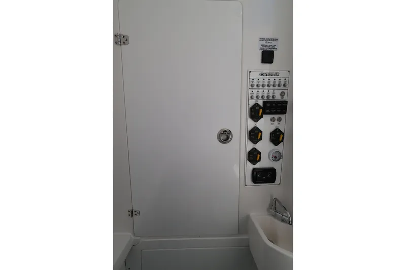 Slide: The Image of Control panel inside 2026 Contender 32 ST boat, featuring switches and gauges. - 36