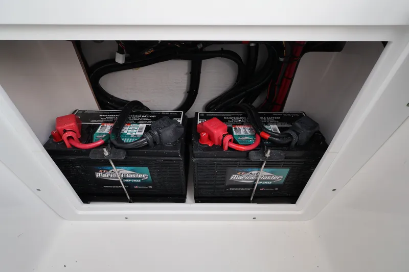 Slide: The Image of Dual marine batteries in a 2026 Contender 32 ST boat compartment. - 39