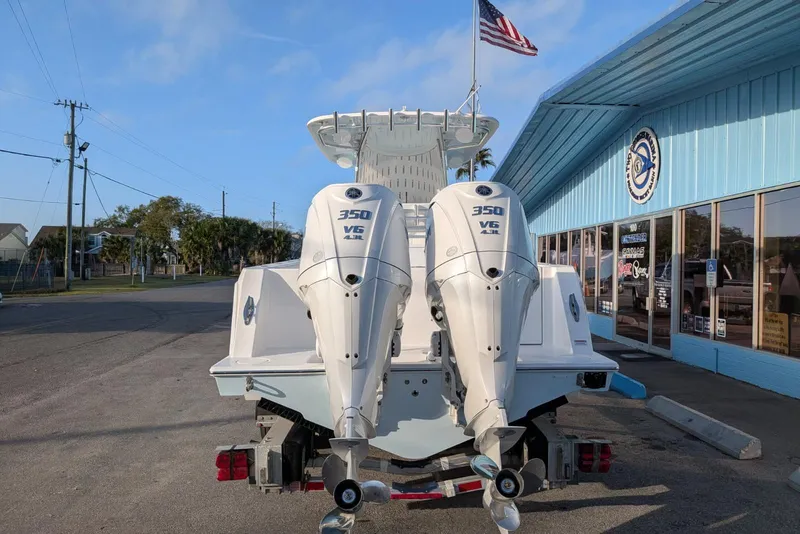 Slide: The Image of 2026 Contender 32 ST boat on trailer with Yamaha engine, parked outdoors. - 4