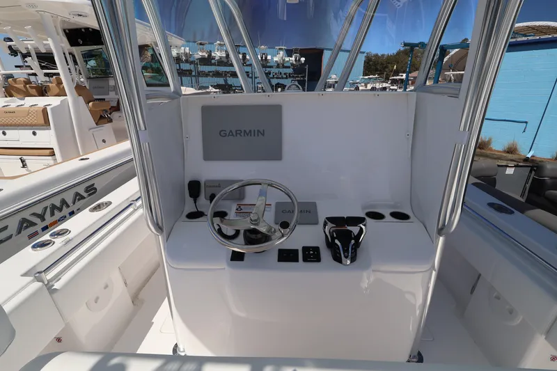 Slide: The Image of 2026 Contender 32 ST boat helm with Garmin navigation system and steering wheel. - 40