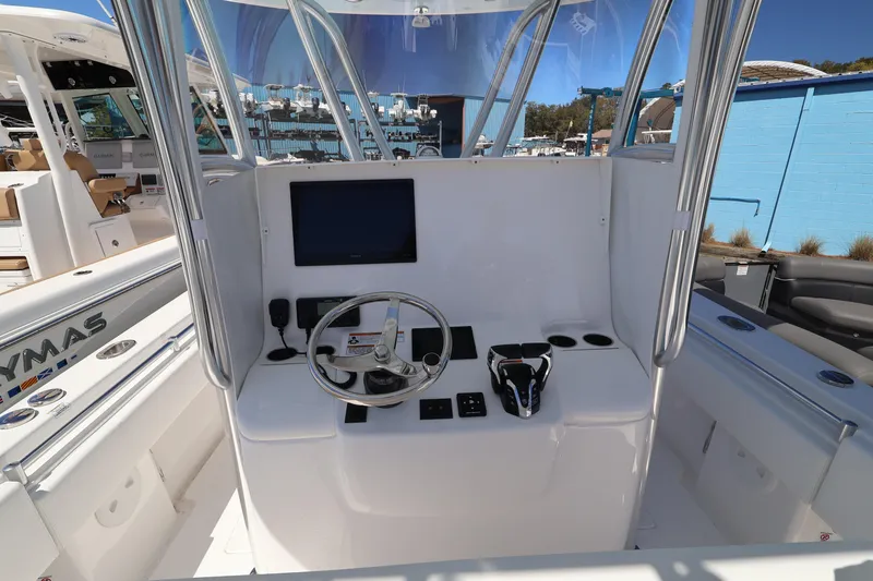 Slide: The Image of 2026 Contender 32 ST boat cockpit with steering wheel and control panel. - 41