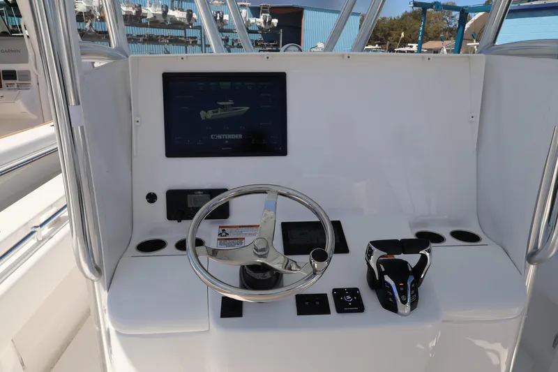 Slide: The Image of Helm of 2026 Contender 32 ST boat with steering wheel and control panel. - 42