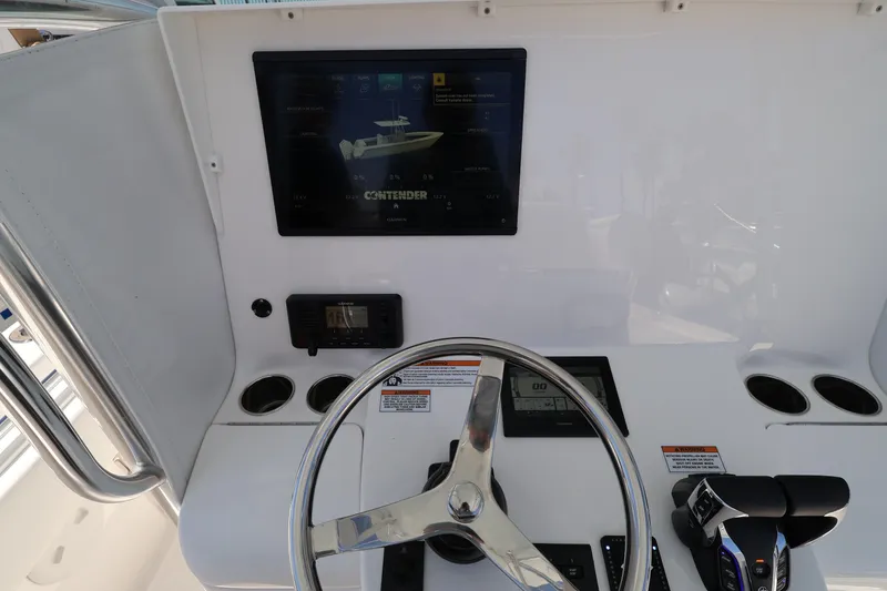 Slide: The Image of Helm of 2026 Contender 32 ST boat with steering wheel and digital display. - 43