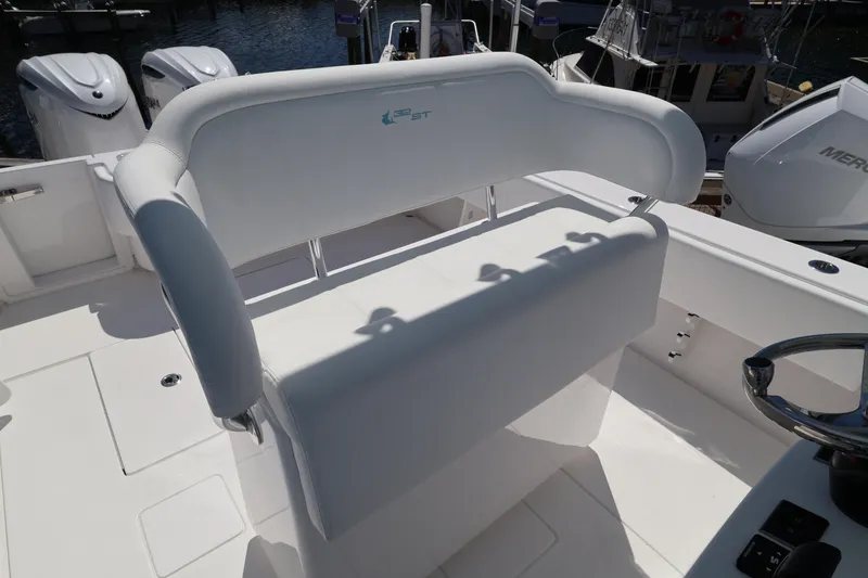 Slide: The Image of 2026 Contender 32 ST boat interior with white seating and dual outboard motors. - 44