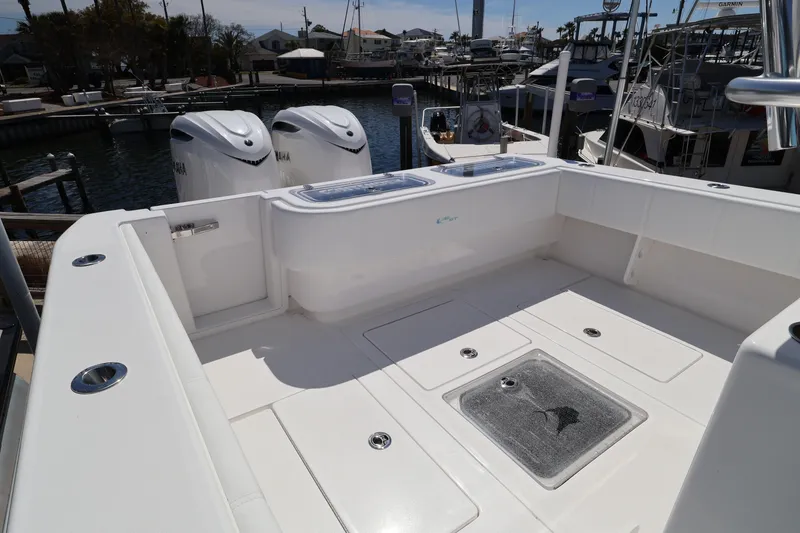 Slide: The Image of 2026 Contender 32 ST boat deck with twin Yamaha engines at marina. - 48