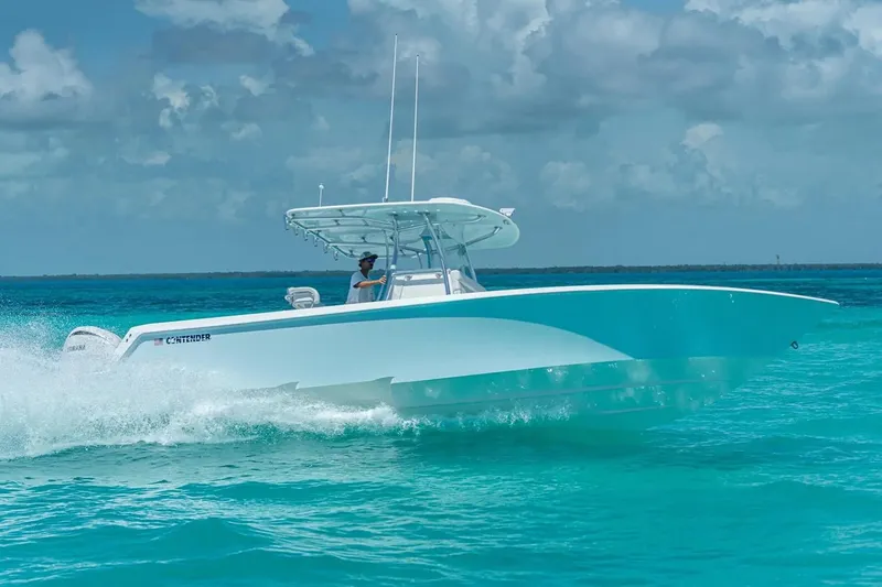 Slide: The Image of 2026 Contender 32 ST boat on trailer in marina under clear blue sky. - 5