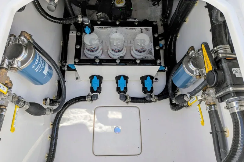 Slide: The Image of Engine compartment of 2026 Contender 32 ST boat, showcasing filters and hoses. - 52
