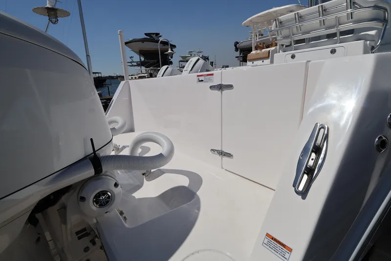 Slide: The Image of 2026 Contender 32 ST boat docked at marina with palm trees and clear sky. - 55