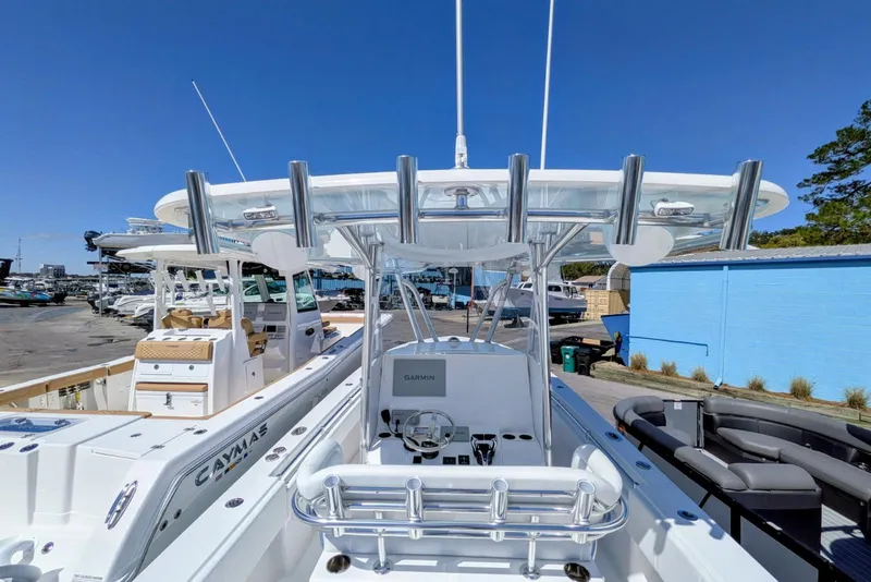 Slide: The Image of 2026 Contender 32 ST boat on trailer, parked near blue building under clear sky. - 57