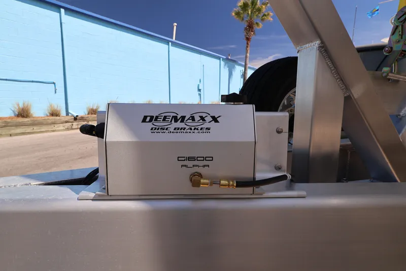 Slide: The Image of 2026 Contender 32 ST boat trailer with mounted spare tire and winch system. - 59