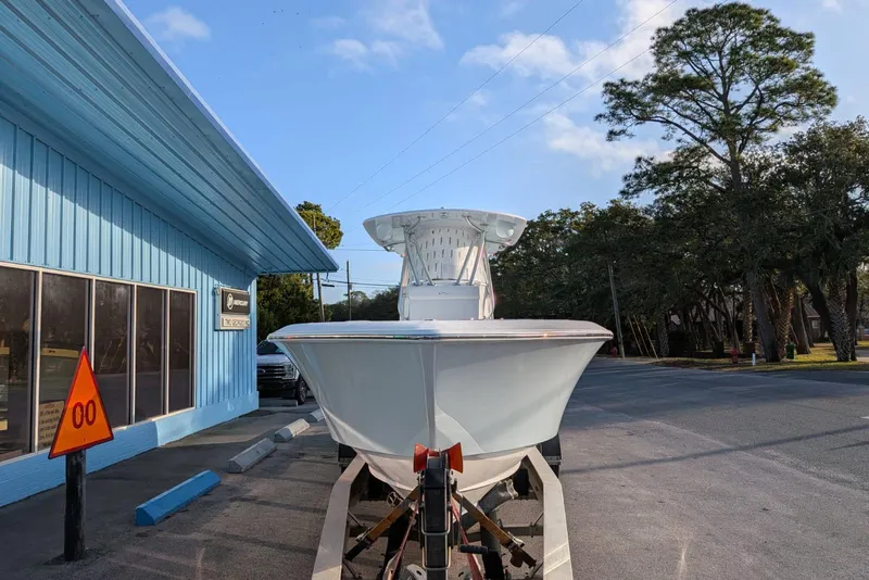 Slide: The Image of 2026 Contender 32 ST boat on trailer under clear blue sky. - 6