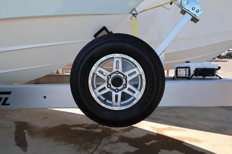 Slide: The Image of 2026 Contender 32 ST boat on trailer, parked outdoors under clear sky. - 60