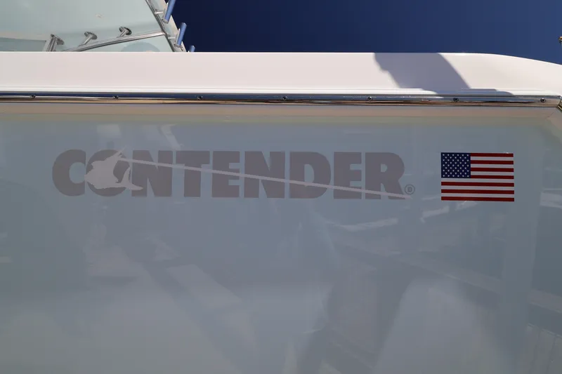 Slide: The Image of 2026 Contender 32 ST boat on trailer in marina under clear blue sky. - 62