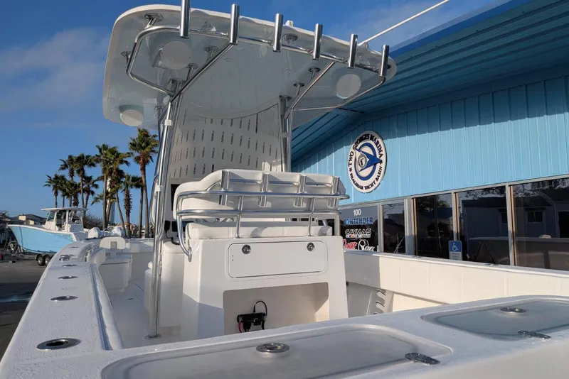 Slide: The Image of 2026 Contender 32 ST boat on trailer in marina under clear blue sky. - 7