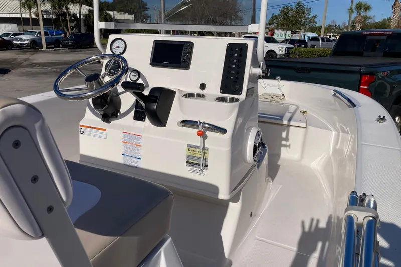 Slide: The Image of 2020 Robalo R160 Center Console boat interior with steering wheel and control panel. - 4