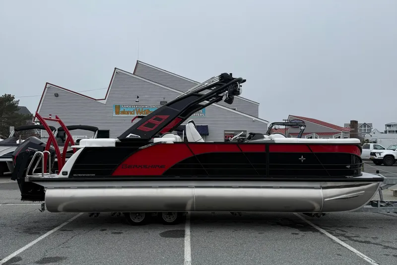 The Image of 2026 Berkshire 23RFX STS pontoon boat in a parking lot, showcasing sleek design. - 1